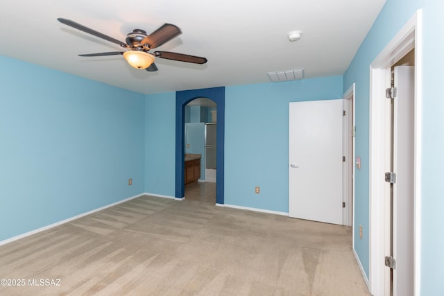 6591 S Avenida Santa Carolina, Tucson, AZ 85756 - unfurnished bedroom with light colored carpet, arched walkways, baseboards, and ensuite bath