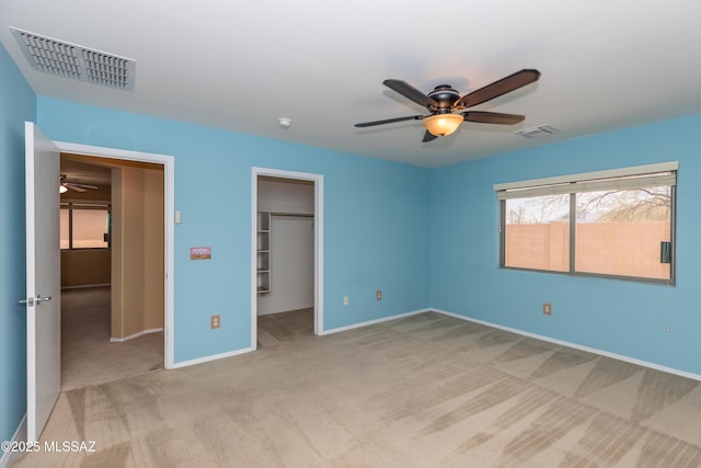 6591 S Avenida Santa Carolina, Tucson, AZ 85756 - unfurnished bedroom with carpet flooring, baseboards, a spacious closet, a closet, and a ceiling fan