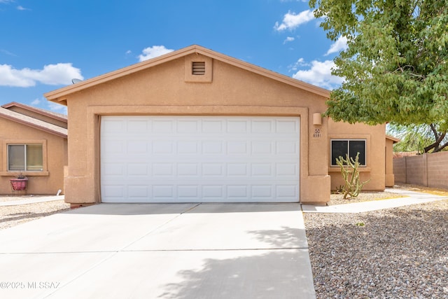 6591 S Avenida Santa Carolina, Tucson, AZ 85756 - view of front of property featuring driveway, an attached garage, stucco siding, and fence