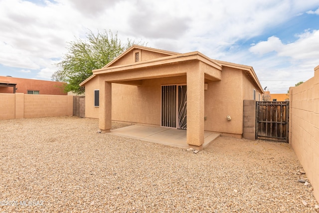 6591 S Avenida Santa Carolina, Tucson, AZ 85756 - back of house featuring a fenced backyard, stucco siding, a gate, and a patio area