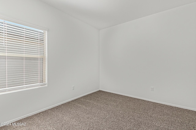 carpeted spare room with baseboards