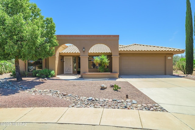 14670 N Wonderview Dr, Oro Valley, AZ 85755 - mediterranean / spanish home featuring a garage, driveway, stucco siding, and a tiled roof