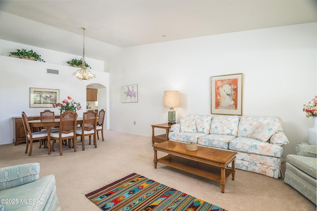 14670 N Wonderview Dr, Oro Valley, AZ 85755 - carpeted living room featuring arched walkways and high vaulted ceiling