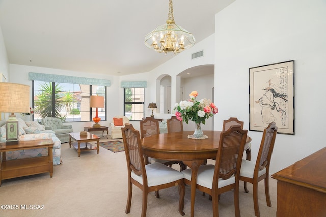 14670 N Wonderview Dr, Oro Valley, AZ 85755 - dining area with a chandelier, light colored carpet, and arched walkways