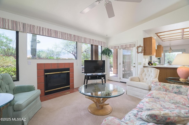 14670 N Wonderview Dr, Oro Valley, AZ 85755 - living room with a tile fireplace, ceiling fan, carpet floors, vaulted ceiling, and tile patterned flooring