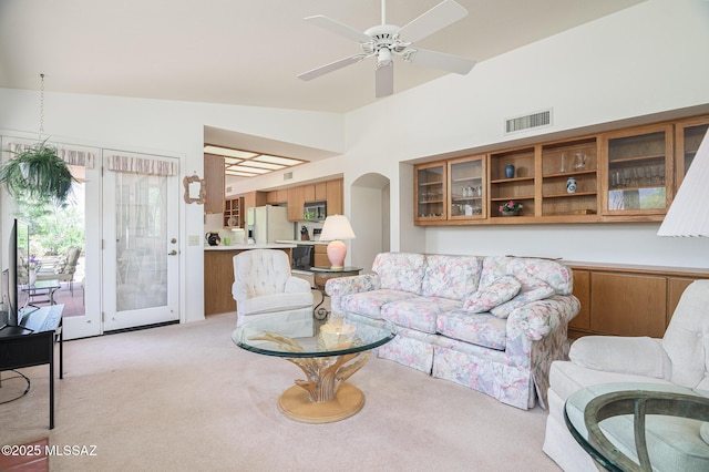 14670 N Wonderview Dr, Oro Valley, AZ 85755 - living room with light colored carpet, ceiling fan, lofted ceiling, and arched walkways
