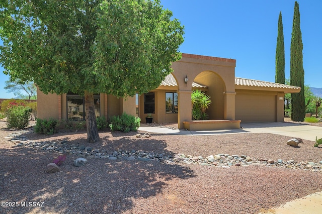 14670 N Wonderview Dr, Oro Valley, AZ 85755 - view of front of property featuring an attached garage, driveway, and stucco siding