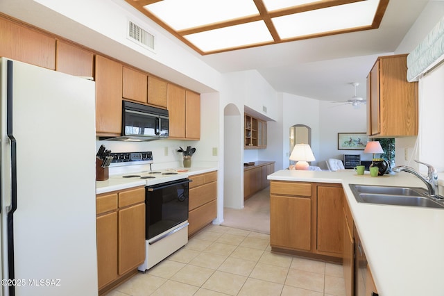 14670 N Wonderview Dr, Oro Valley, AZ 85755 - kitchen featuring freestanding refrigerator, range with electric stovetop, black microwave, a sink, and light countertops