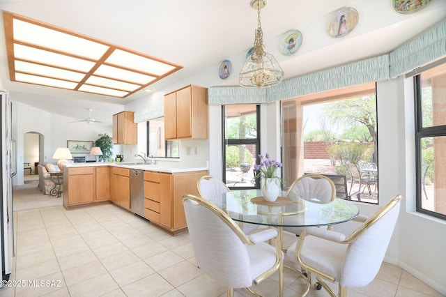 14670 N Wonderview Dr, Oro Valley, AZ 85755 - kitchen featuring stainless steel dishwasher, a sink, light countertops, light tile patterned floors, and healthy amount of natural light