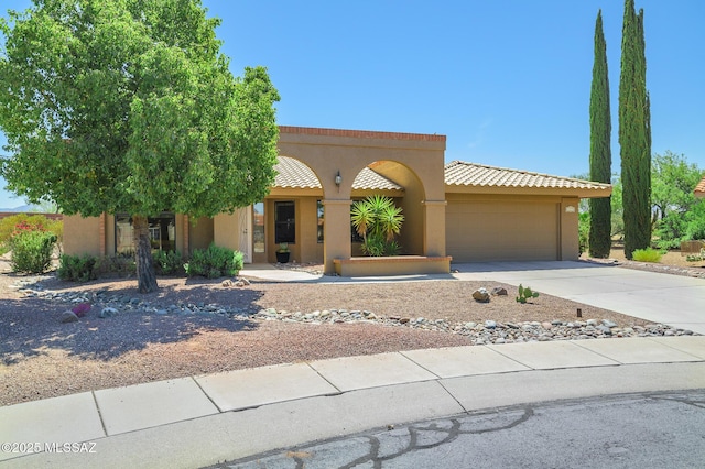 14670 N Wonderview Dr, Oro Valley, AZ 85755 - view of front of house with an attached garage, driveway, stucco siding, and a tile roof