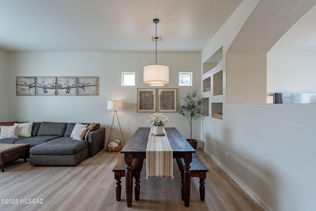 dining room featuring wood finished floors and baseboards