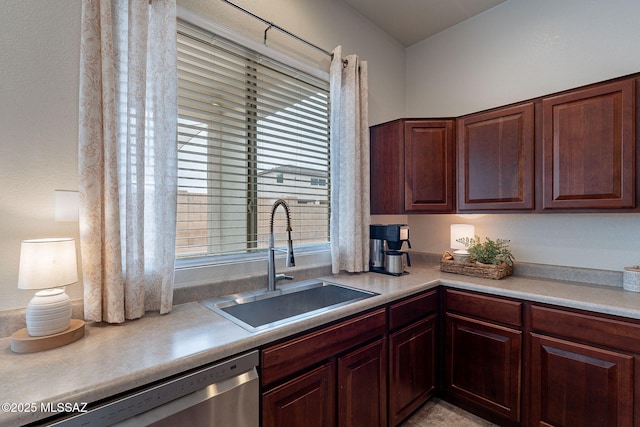kitchen featuring a sink, stainless steel dishwasher, and light countertops