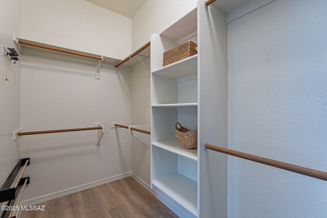 spacious closet with wood finished floors