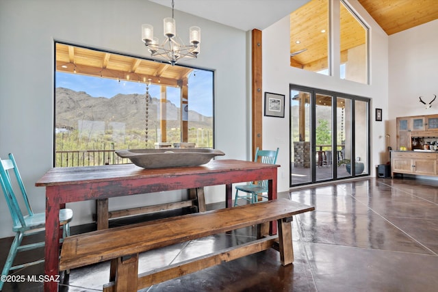 6695 W Banded Gecko Way, Tucson, AZ 85745 - dining room featuring finished concrete floors, a mountain view, and a chandelier