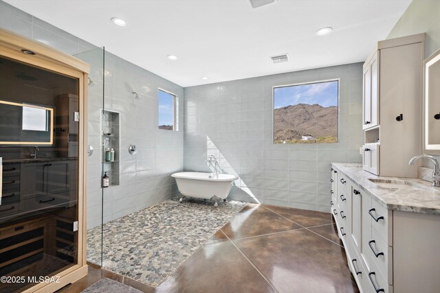 6695 W Banded Gecko Way, Tucson, AZ 85745 - bathroom featuring tile walls, a tile shower, vanity, a soaking tub, and recessed lighting