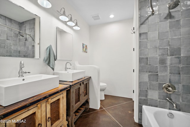 6695 W Banded Gecko Way, Tucson, AZ 85745 - bathroom with toilet, tile patterned floors, tub / shower combination, and two vanities