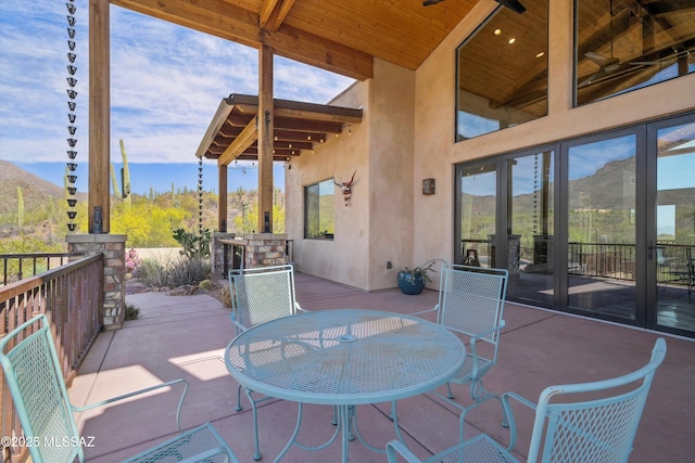 6695 W Banded Gecko Way, Tucson, AZ 85745 - view of patio with a mountain view, french doors, outdoor dining area, and a ceiling fan