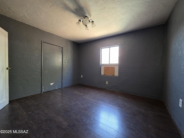 3638 S Bronson Ave, Tucson, AZ 85713 - unfurnished bedroom featuring a textured wall, wood finished floors, and a textured ceiling