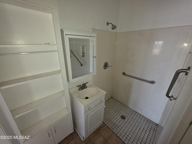 3638 S Bronson Ave, Tucson, AZ 85713 - bathroom featuring tile patterned flooring, a stall shower, and vanity