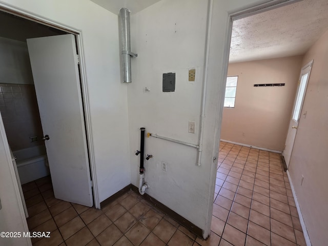 3638 S Bronson Ave, Tucson, AZ 85713 - washroom with tile patterned floors, a textured ceiling, and baseboards