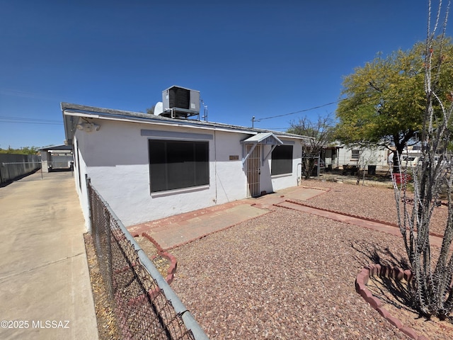3638 S Bronson Ave, Tucson, AZ 85713 - back of house featuring central AC unit, stucco siding, and fence