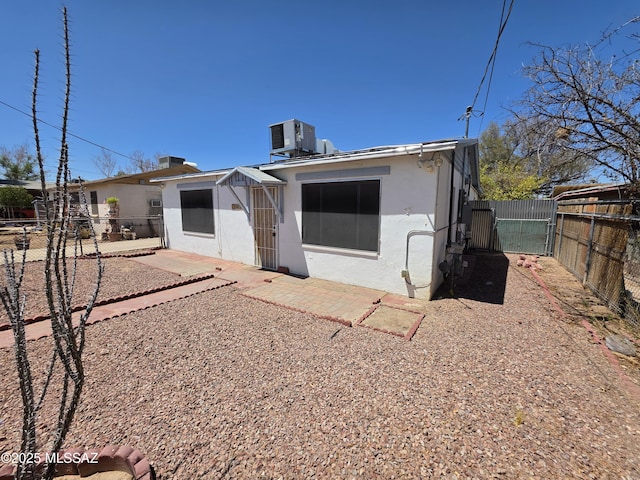 3638 S Bronson Ave, Tucson, AZ 85713 - rear view of property featuring a gate, a fenced backyard, central AC, stucco siding, and a patio area