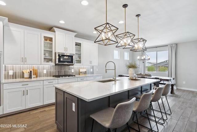 11479 N Desert Calico Loop, Tucson, AZ 85742 - kitchen with a sink, stainless steel microwave, gas stovetop, a chandelier, and recessed lighting