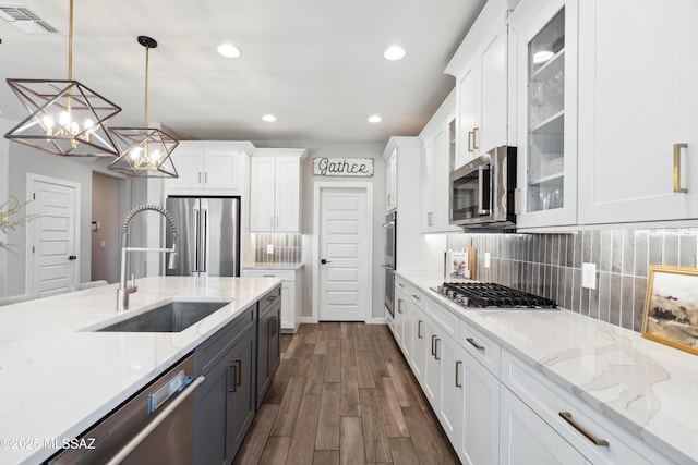 11479 N Desert Calico Loop, Tucson, AZ 85742 - kitchen featuring appliances with stainless steel finishes, a sink, white cabinetry, glass insert cabinets, and recessed lighting
