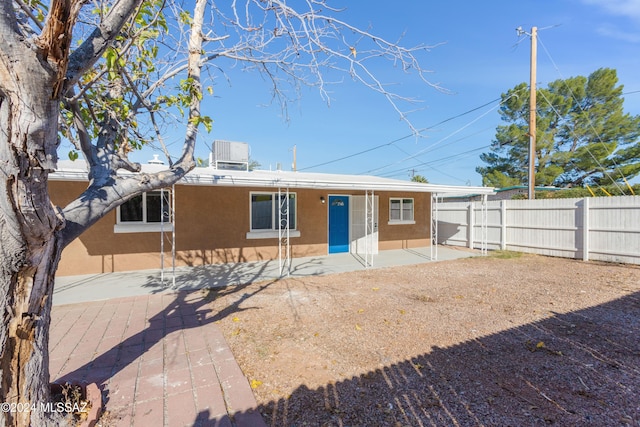 4029 E Fort Lowell Rd, Tucson, AZ 85712 - back of property with stucco siding, fence, and a patio