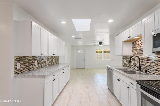 4029 E Fort Lowell Rd, Tucson, AZ 85712 - kitchen featuring a sink, appliances with stainless steel finishes, a skylight, backsplash, and recessed lighting
