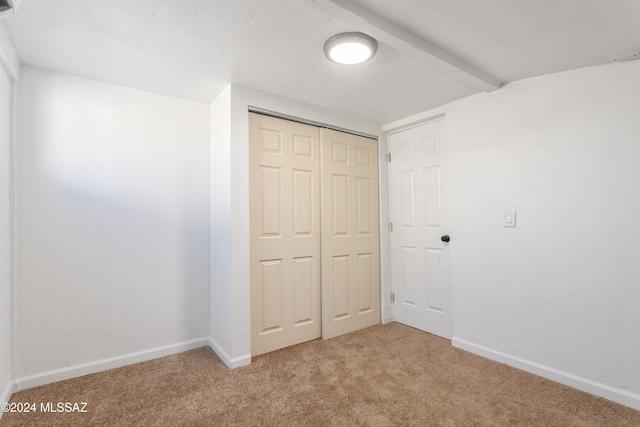4029 E Fort Lowell Rd, Tucson, AZ 85712 - unfurnished bedroom with light colored carpet, a closet, and baseboards