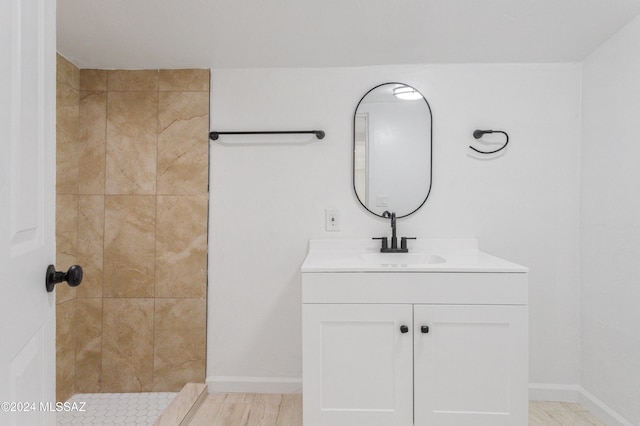 4029 E Fort Lowell Rd, Tucson, AZ 85712 - bathroom featuring vanity, tiled shower, and baseboards