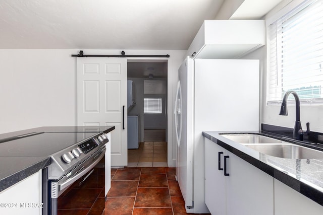 4367 N Radin Ave, Tucson, AZ 85705 - kitchen with dark countertops, stainless steel range with electric stovetop, a wealth of natural light, and a sink