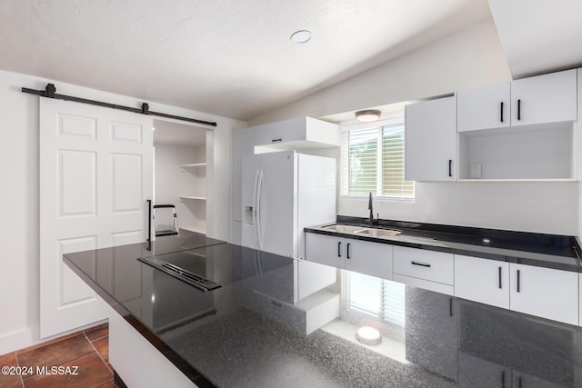4367 N Radin Ave, Tucson, AZ 85705 - kitchen with a sink, open shelves, a barn door, white cabinetry, and white refrigerator with ice dispenser