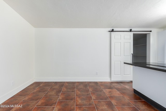 4367 N Radin Ave, Tucson, AZ 85705 - empty room with baseboards and a barn door