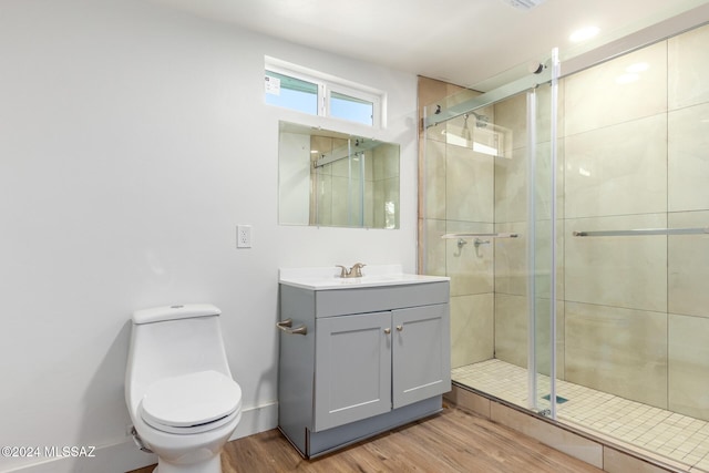 4367 N Radin Ave, Tucson, AZ 85705 - bathroom with vanity, toilet, wood finished floors, and a stall shower
