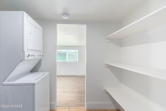 4367 N Radin Ave, Tucson, AZ 85705 - laundry room featuring laundry area, stacked washer and dryer, and baseboards