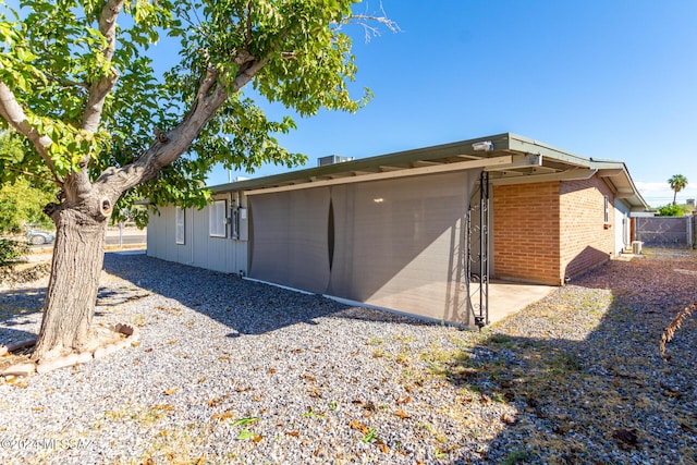 4367 N Radin Ave, Tucson, AZ 85705 - view of home's exterior with fence and brick siding