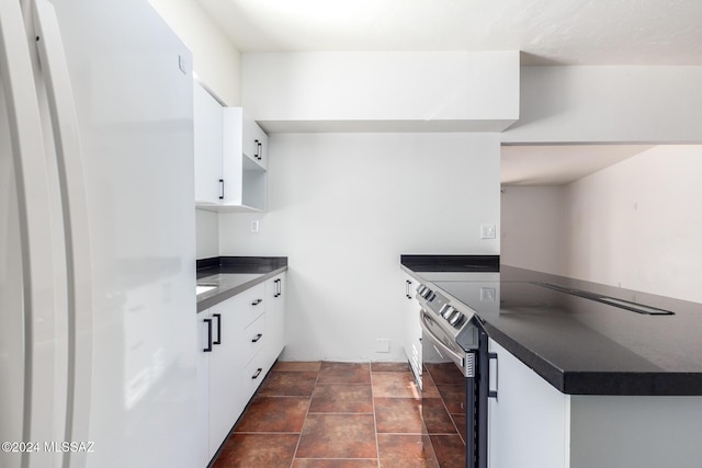 4367 N Radin Ave, Tucson, AZ 85705 - kitchen with a peninsula, dark countertops, and white cabinets