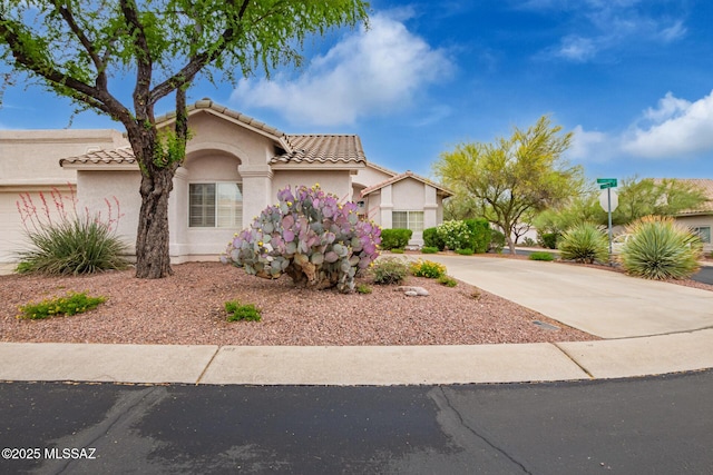 1497 W Carmel Pointe Dr, Oro Valley, AZ 85737 - view of front of house with driveway, stucco siding, and a tile roof