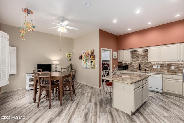 1497 W Carmel Pointe Dr, Oro Valley, AZ 85737 - kitchen featuring white dishwasher, stainless steel microwave, a ceiling fan, light wood-style floors, and recessed lighting