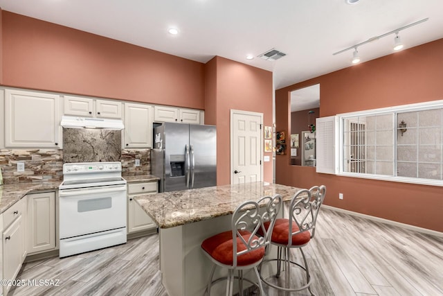 1497 W Carmel Pointe Dr, Oro Valley, AZ 85737 - kitchen featuring stainless steel fridge with ice dispenser, white range with electric stovetop, under cabinet range hood, light wood-style floors, and recessed lighting