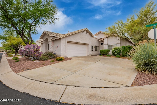 1497 W Carmel Pointe Dr, Oro Valley, AZ 85737 - view of front facade with stucco siding, a garage, driveway, and a tiled roof
