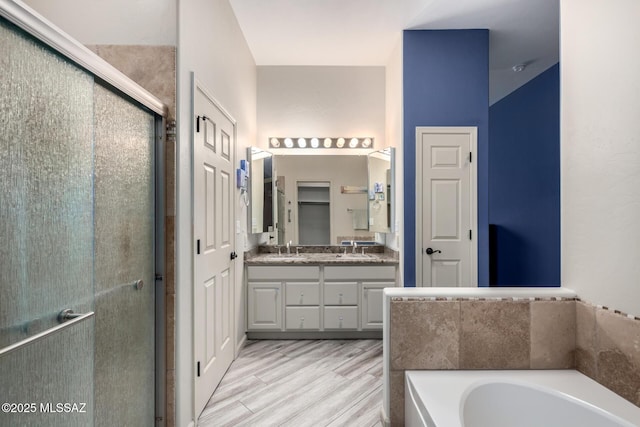 1497 W Carmel Pointe Dr, Oro Valley, AZ 85737 - full bathroom with a stall shower, a bath, double vanity, and wood finished floors