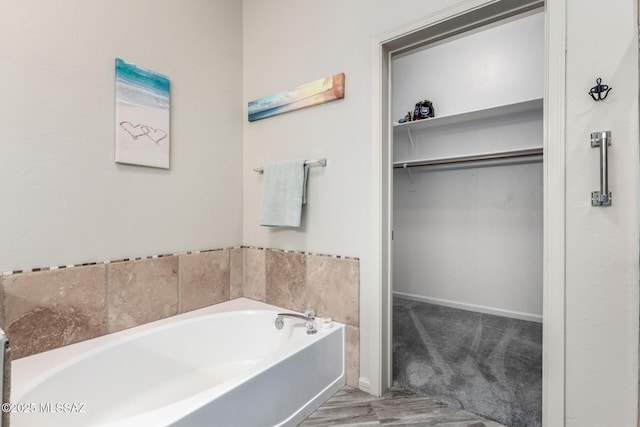 1497 W Carmel Pointe Dr, Oro Valley, AZ 85737 - full bath featuring a garden tub, a spacious closet, and baseboards