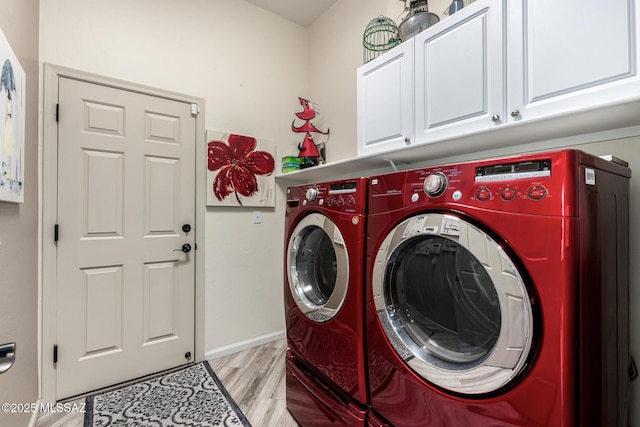 1497 W Carmel Pointe Dr, Oro Valley, AZ 85737 - clothes washing area featuring cabinet space, washer and dryer, and light wood-style flooring