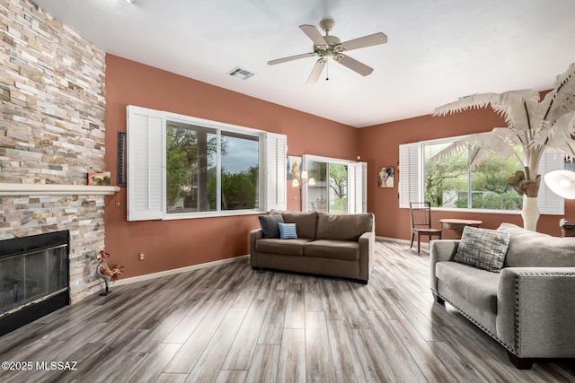 1497 W Carmel Pointe Dr, Oro Valley, AZ 85737 - living area with wood finished floors, a ceiling fan, baseboards, and a fireplace