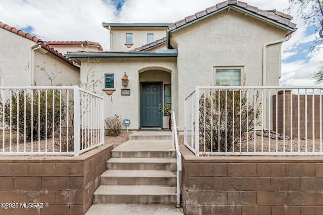 10560 E Forest Falls Ct, Tucson, AZ 85747 - entrance to property featuring fence, stucco siding, and a tiled roof