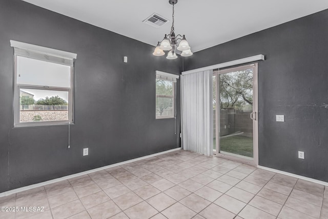 10560 E Forest Falls Ct, Tucson, AZ 85747 - empty room featuring a chandelier, light tile patterned floors, and baseboards
