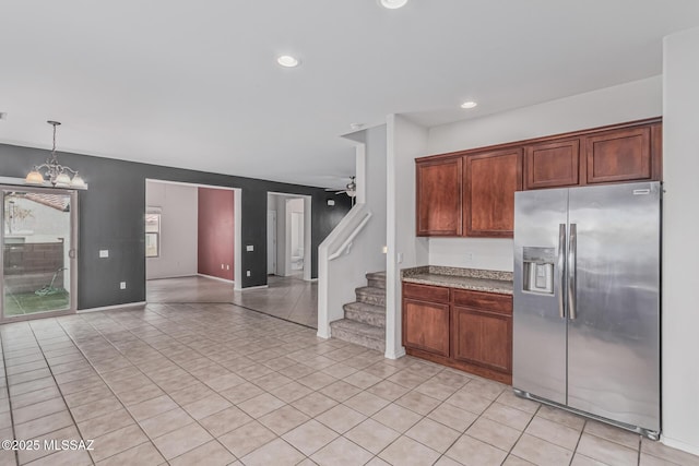 10560 E Forest Falls Ct, Tucson, AZ 85747 - kitchen with stainless steel fridge with ice dispenser, a chandelier, light tile patterned floors, recessed lighting, and pendant lighting